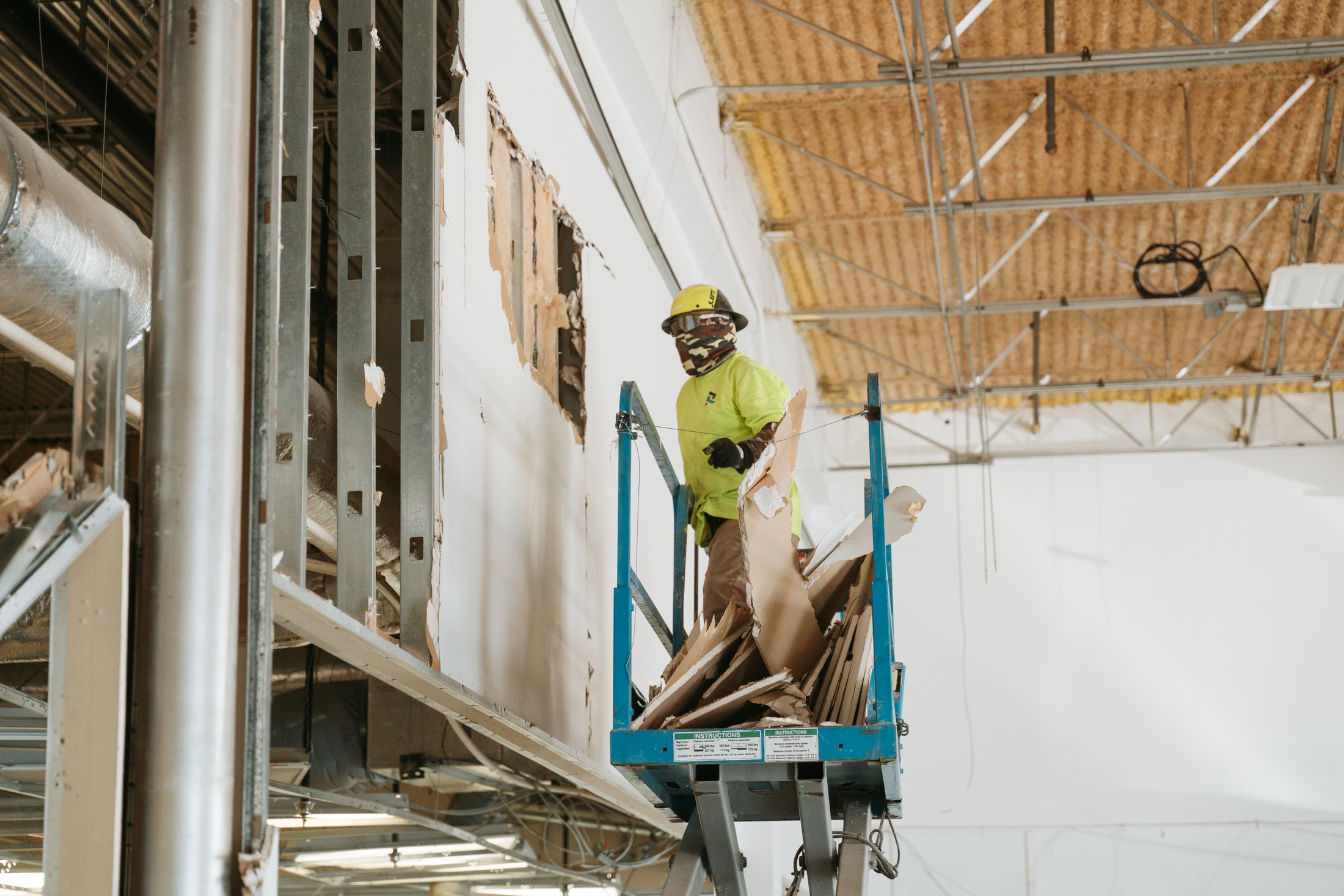 Resolver crew member on a lift during high-bay demolition at Brockwood