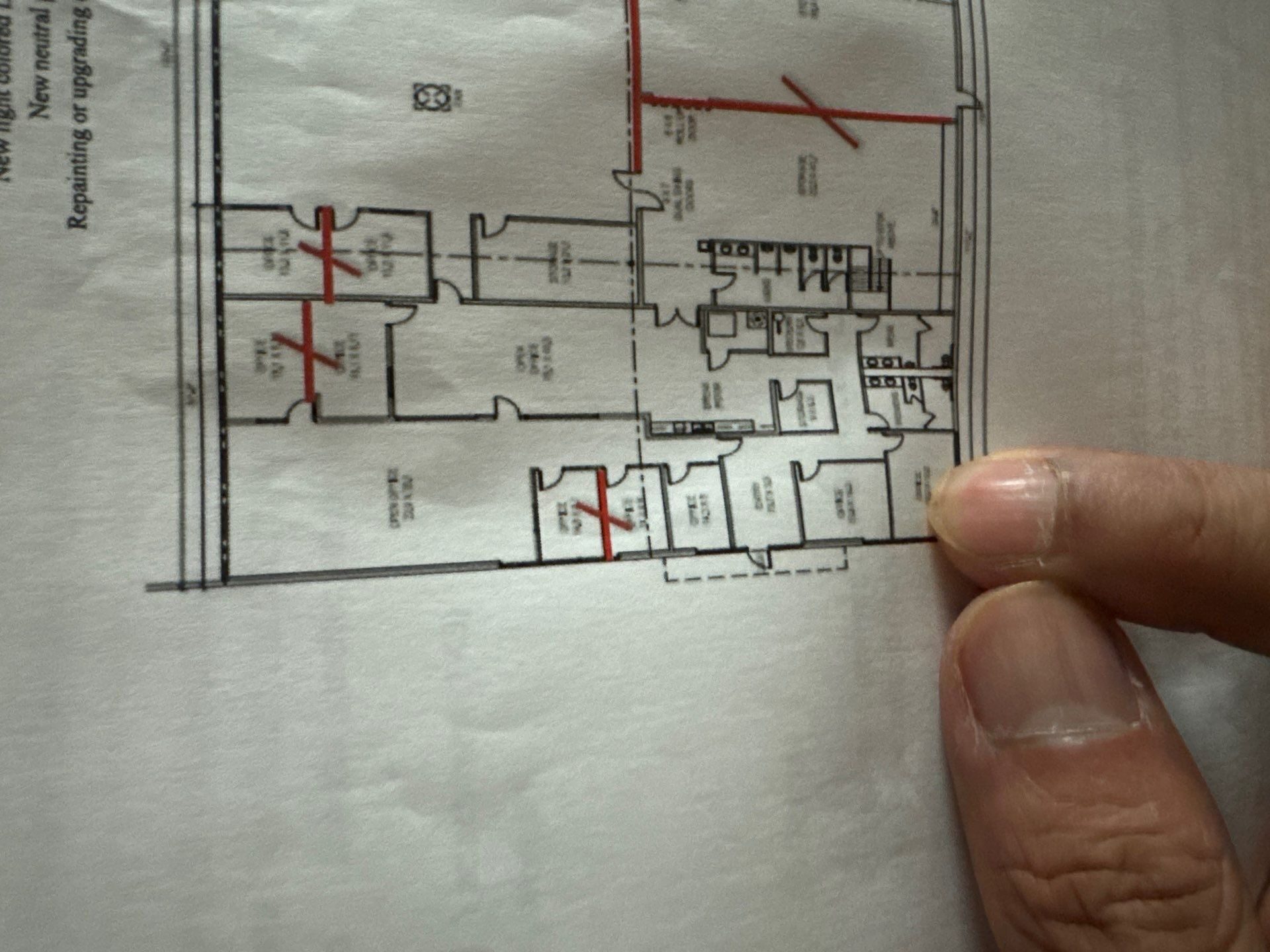 Reviewing the floor plan on site before the Élan Beauté renovation