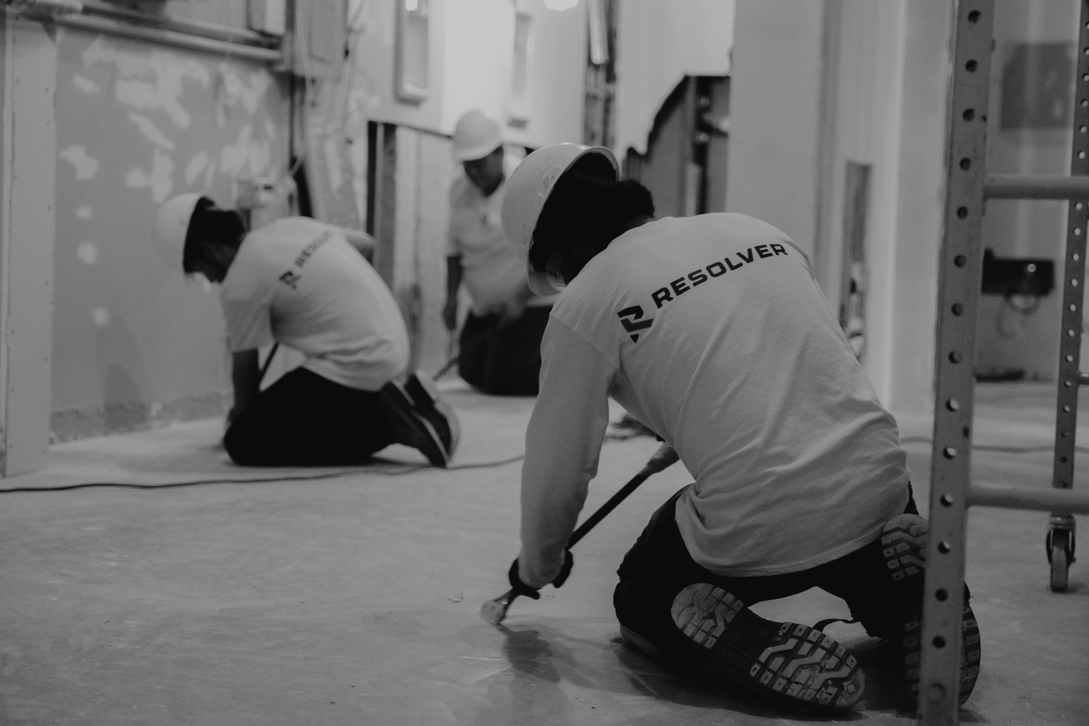 Resolver crew members finishing floors on the Nooma project in Dallas, TX
