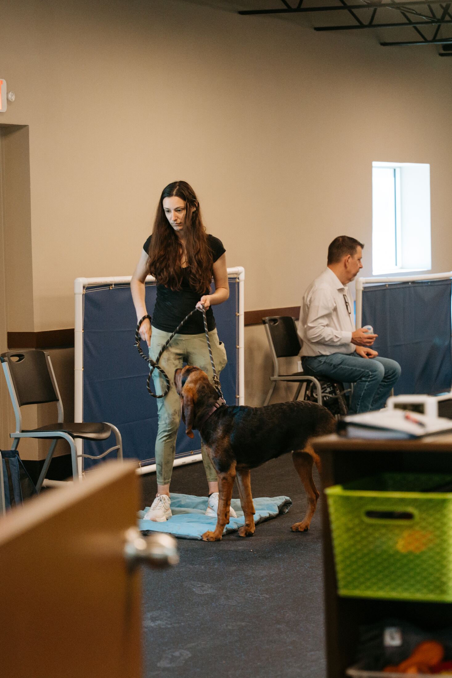 Trainer working leash exercises with a dog and client
