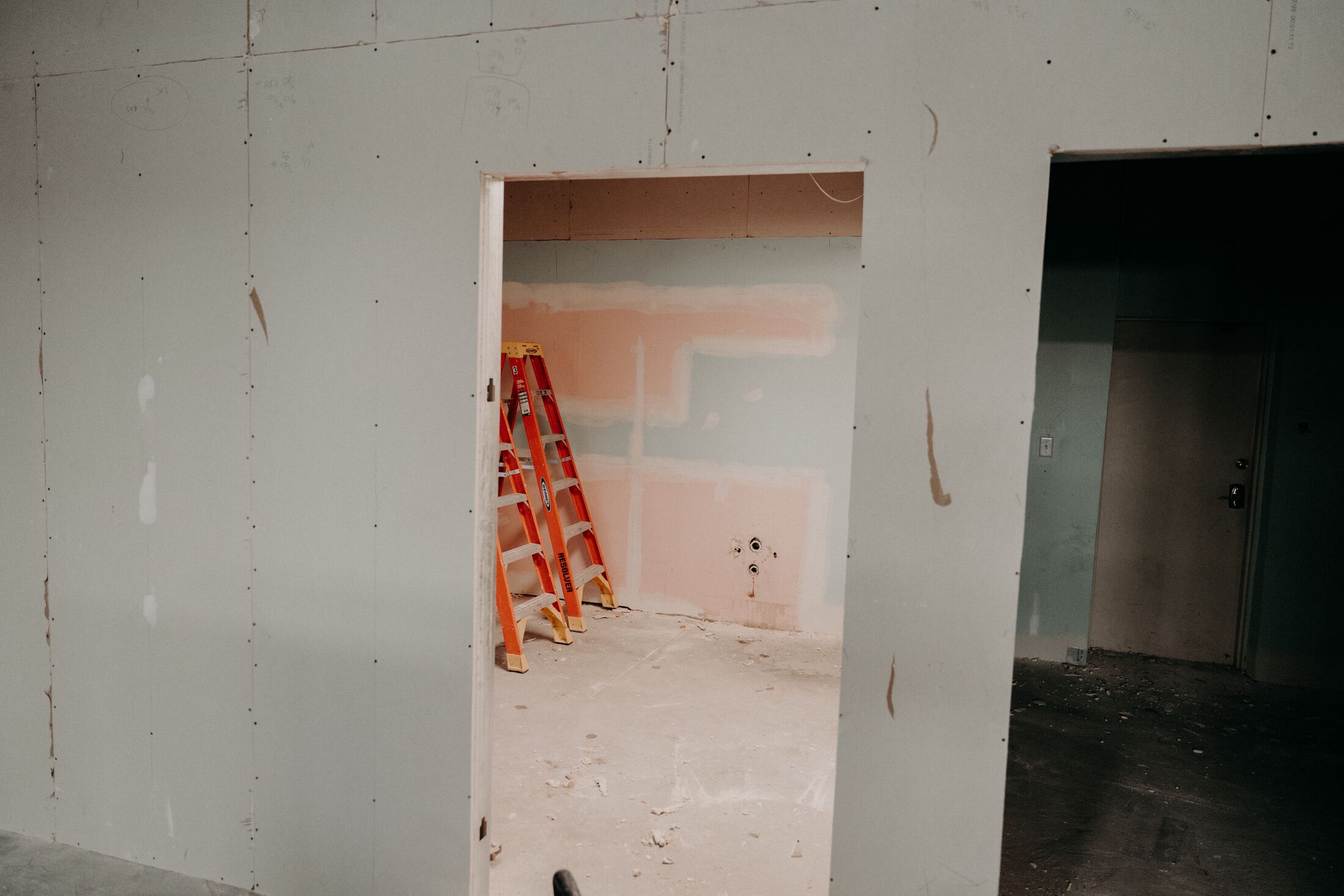 Framed doorway and drywall patch during early construction