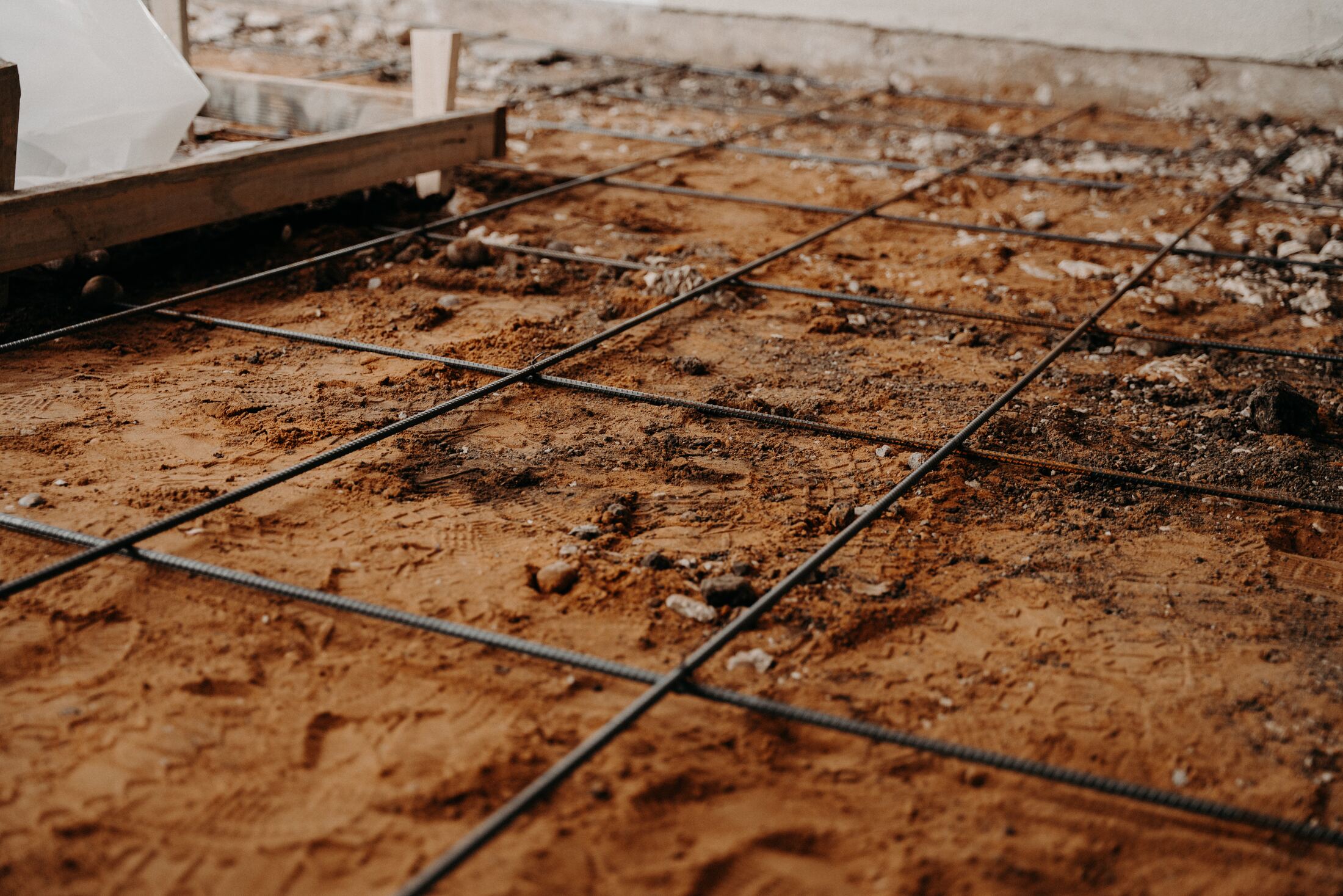 Rebar grid and gravel bed prepped for the courtyard concrete pour